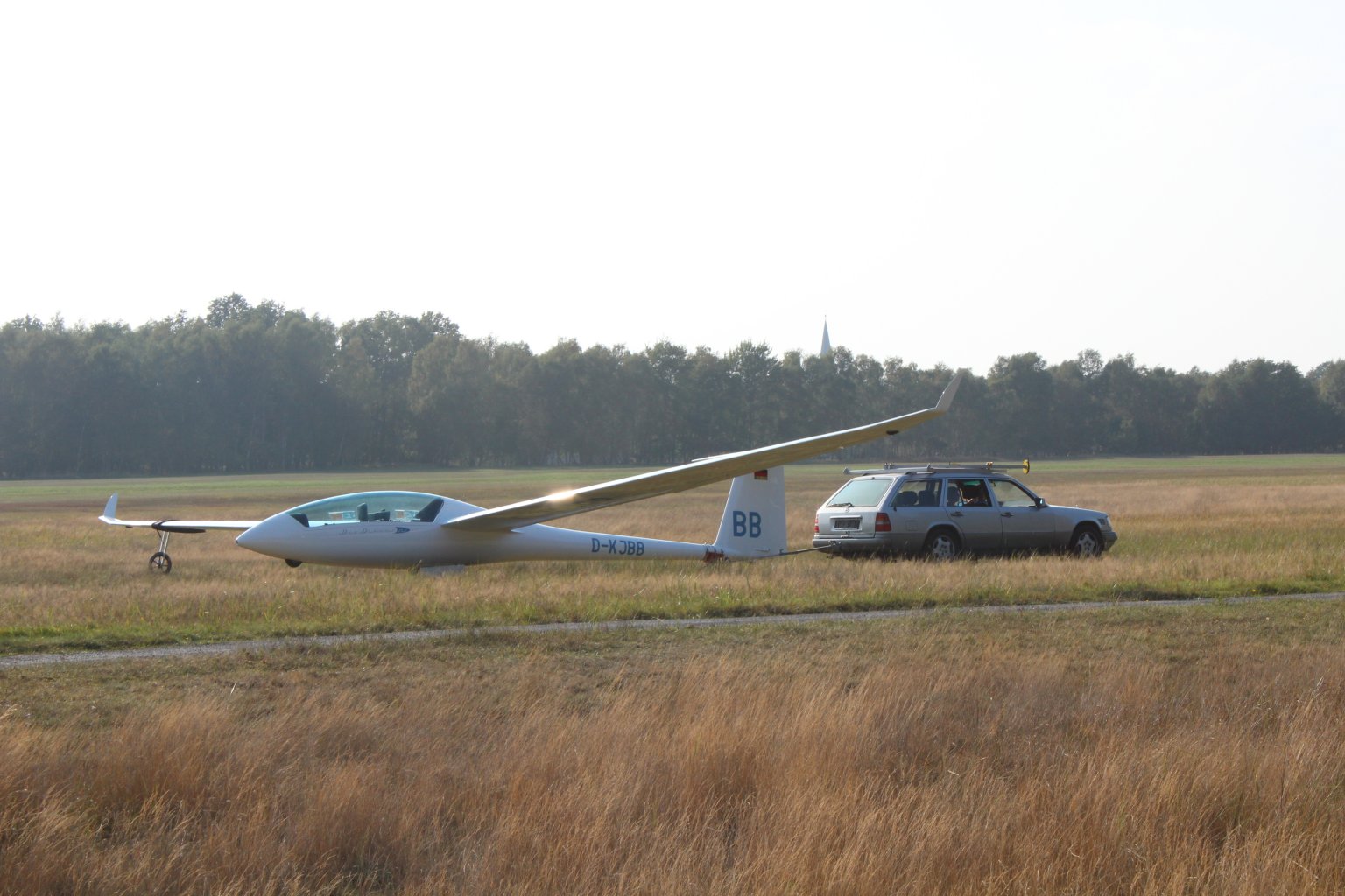 A glider being towed back to the Boberg airfield staging area after landing